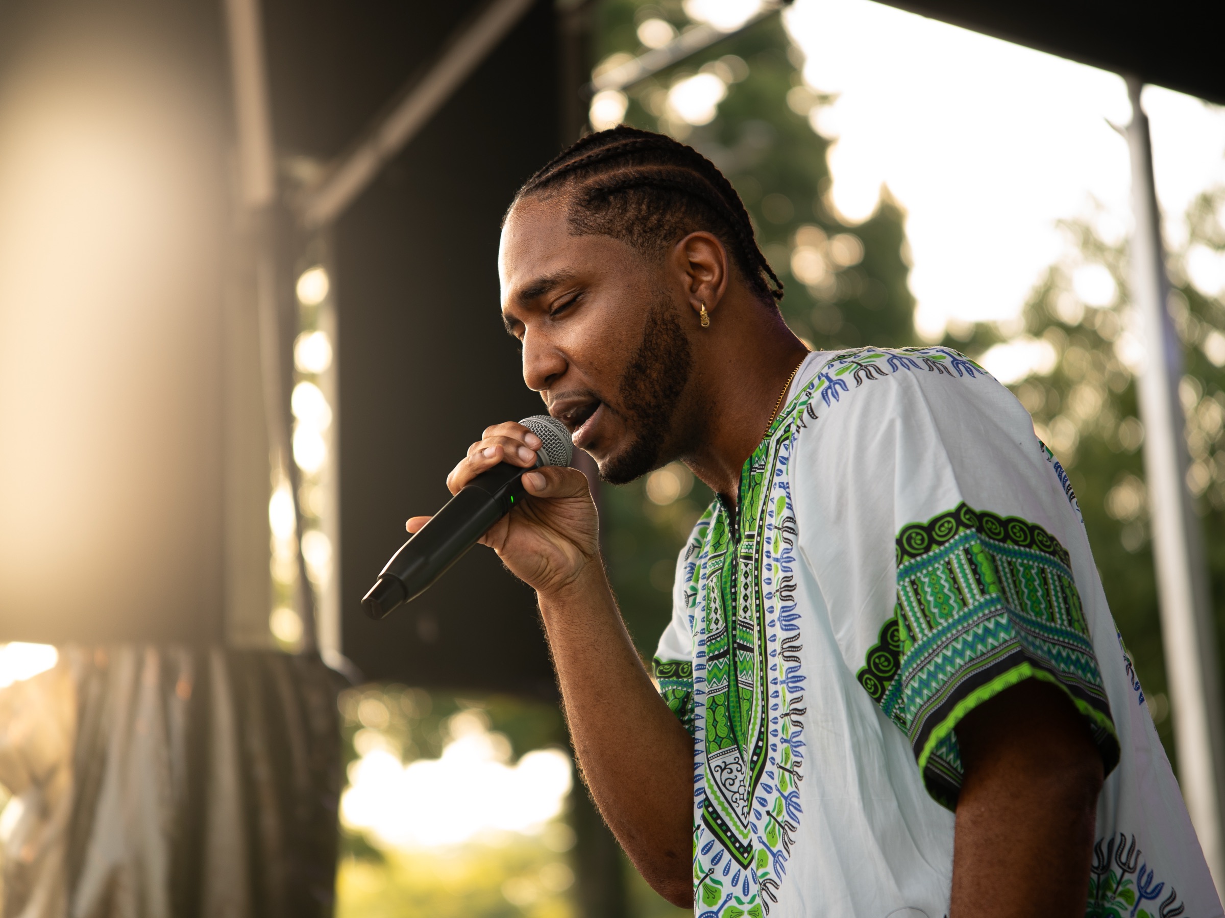 A singer performing on stage at the Kuumba Festival.
