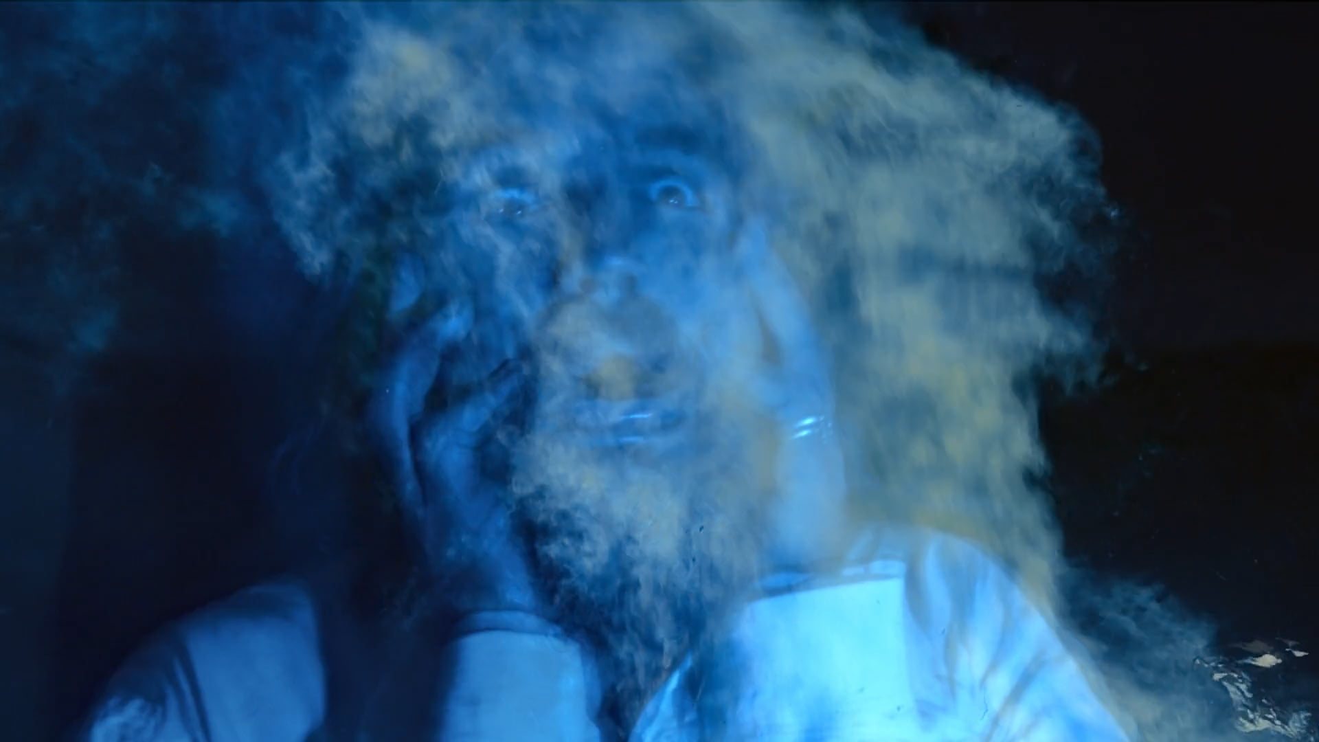 A man lit blue, engulfed in gas, from the Stop NW Gas trailer.